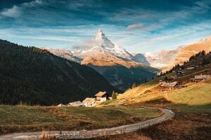 Landscape of Matterhorn mountain and rustic village on hill in Switzerland photo