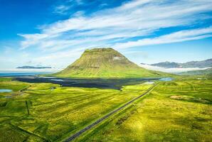 Majestic Kirkjufell volcanic mountain with foggy on Atlantic ocean in summer at Snaefellsnes peninsula, Iceland photo