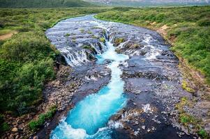 Bruarfoss waterfall flowing from Bruara river on wilderness in summer at Iceland photo