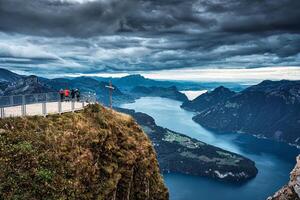 fronalpstock con cruzar y turista de viaje en cumbre y temperamental cielo con vista a lago alfalfa a Schwyz, Suiza foto