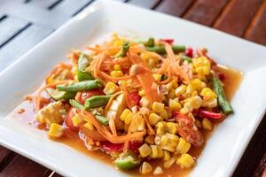 Corn seeds with fruits and vegetables sour spicy in plate photo