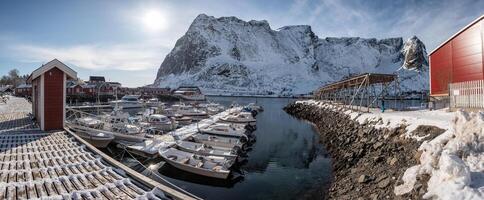 Lofoten islands with fishing village and boats on coastline in winter at Norway photo