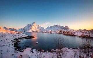 Winter wonderland of Reine town fishing village with fjord mountain in the morning at Lofoten Islands photo