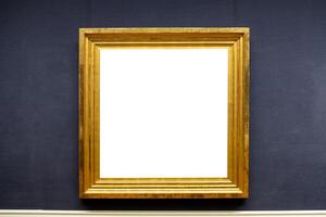 Blank antique golden carved picture frame on wall photo