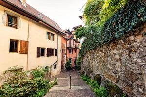 Architecture medieval old town exterior building, narrow alley street in city of Annecy photo