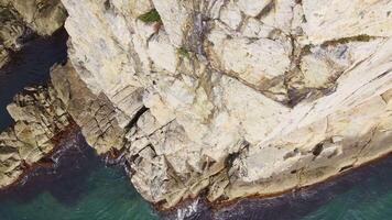 Aerial top down view of the beautiful rocky cape with sheer cliffs video