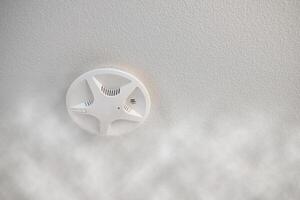 Install fire alarm signal protection on ceiling with smoke effect photo