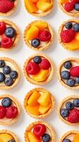 AI generated Fruit Tartlets, variety of fruit tartlets arranged in a visually appealing pattern on a white background, background image, generative AI photo