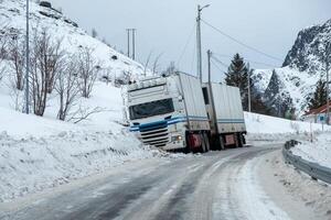 Trailer truck accident slippery on snow pavement photo