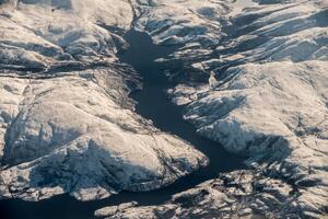 Fjord mountain range in arctic circle ocean on winter photo