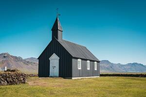 Budakirkja is the famous black church in summer at Iceland photo