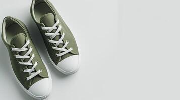 AI generated Olive canvas shoes isolated on flat white background with copy space for advertisement. Generative AI photo
