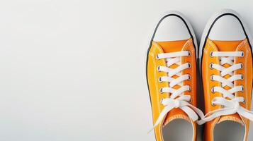 AI generated Orange canvas shoes isolated on flat white background with copy space for advertisement. Generative AI photo