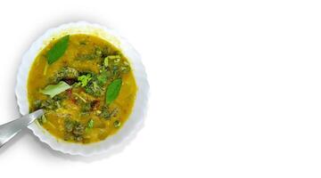 Traditional south indian snack dal sambhar soup with curry leaves photo