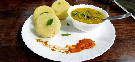 South indian breakfast idli, sambar and coconut chutney photo