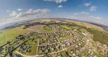 tiny planet in sky with clouds overlooking village and urban development. Transformation of spherical 360 panorama in abstract aerial view. video