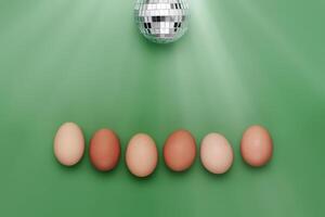 Row of eggs under disco ball. Fun Easter background photo