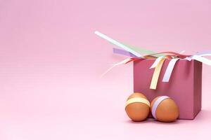 Easter eggs in front of pink square box on empty background photo