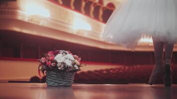 Close-up of a ballerina's legs dancing around a bouquet of flowers. Worldwide recognition. A ballerina's dream. The main role in ballet performance. Solo ballerina. Bravo. video