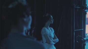 Two ballerinas from behind the scenes watch the performance on stage. The secret of the ballet. Intrigues. Spying on competitors. video