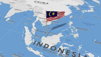 Malaysia bandiera agitando con il mondo carta geografica, senza soluzione di continuità ciclo continuo nel vento, 3d interpretazione video