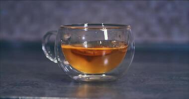 Transparent glass cup with dried fruit compote. ANAMORPHOUS video