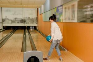 mayor mujer en un bolos club lanza un pelota foto