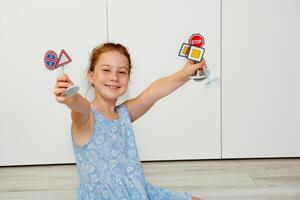 cute little girl holding toy road signs in her hands photo