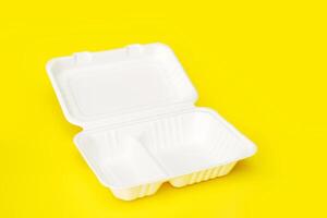 empty open container for food, lunchbox, recycled on yellow background photo