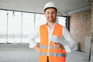 Close up engineers working on a building site holding a blueprints.Engineering and architecture concept photo