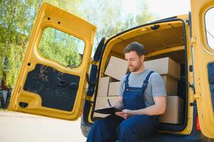 The courier brought the delivery of the box to the client. Courier service employee in uniform. photo