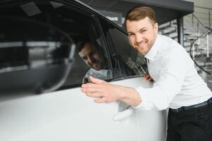 Man buying a car at a showroom photo