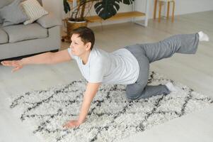 Middle age woman smiling happy doing exercise and stretching at home photo