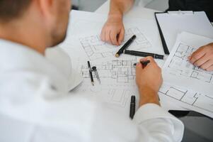 Team of architects people in group on construciton site check documents and business workflow photo