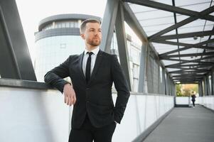 Handsome male model posing wearing a back suit. photo