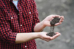 Soil in farmer arms. image with selective focus. photo