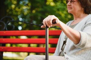 Woman with her walking stick in the park. photo