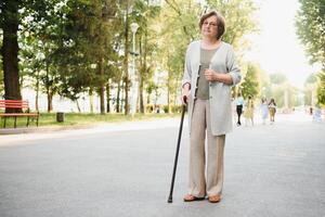 mayor mujer caminando en el parque en verano. foto