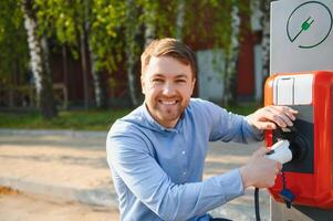 Man Holding Power Charging Cable For Electric Car. photo