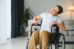 Woman in wheelchair working out in living room photo