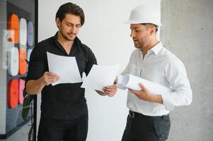 Architect concept, Architects working with blueprints in the office photo