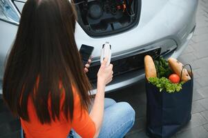 Woman is charging rental electric car photo