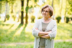 Smiling senior woman having recreation in park. photo