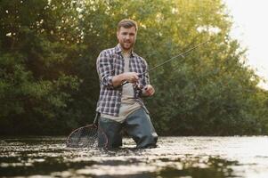 Male hobby. Ready for fishing. Relax in natural environment. Trout bait. Bearded elegant man. Man relaxing nature background. Strategy. Hobby sport activity. Activity and hobby. Catching and fishing photo