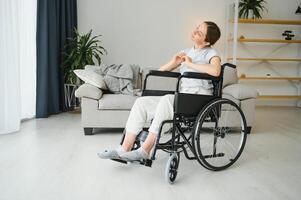 Woman in wheelchair working out in living room photo