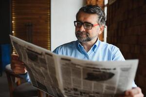 Business man reading a newspaper, cafe backgrounds photo