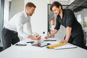 Architect concept, Architects working with blueprints in the office photo