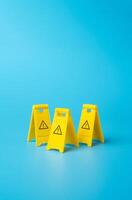 Warning yellow clamshell floor signs. Identify dangers and threats. On the approach to a difficult challenge. Deal with problems. Solve the problem with knowledge of the entire situation. photo