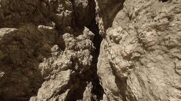 A rock formation with a narrow opening in the middle video