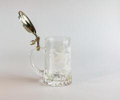 Empty beer glass on a white background. Crystal beer mug. photo